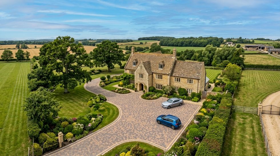 Aerial view of a block paved driveway and turning circle at a stone farmhouse