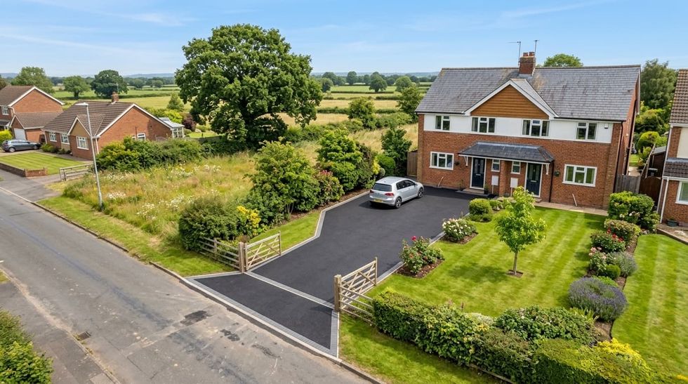 Aerial view of a tarmac driveway with a block paved apron at a semi-detached house